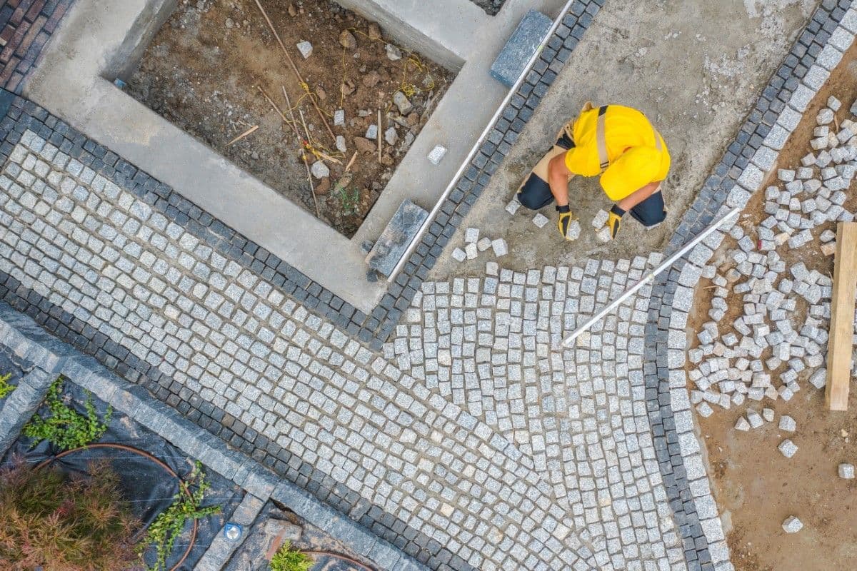 Landscaper laying a stone path